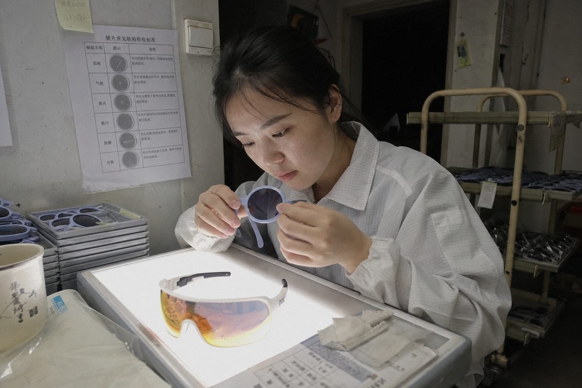Inspecting lenses under light for scratches, peeling, haze, and coating defects before bulk approval (ID#2)
