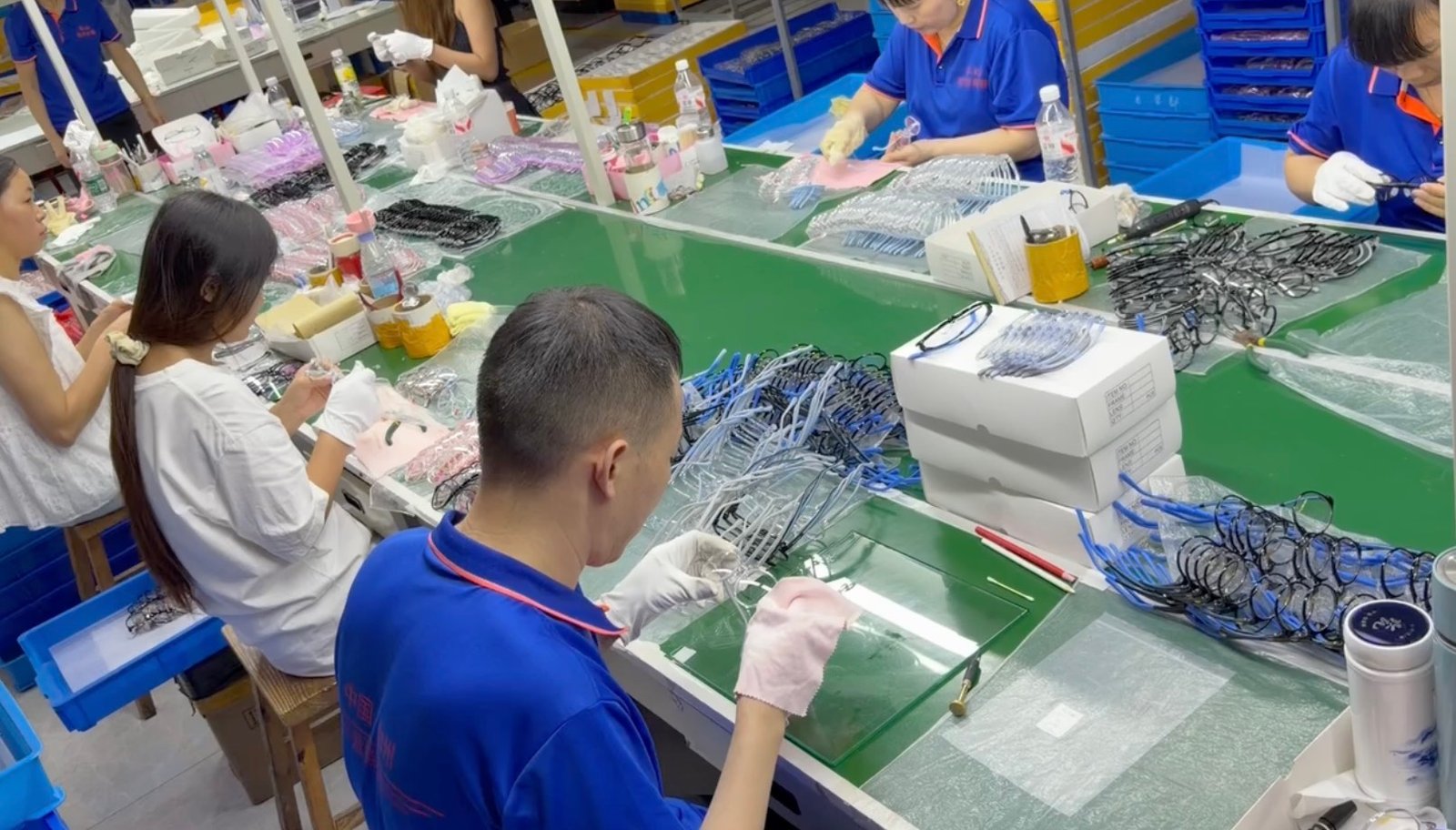 Quality inspector checking finished eyewear before packaging and shipment