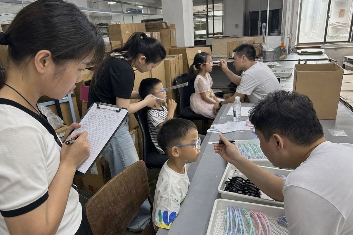 Optician correcting common fitting mistakes when measuring children's eyeglass frames (ID#5)