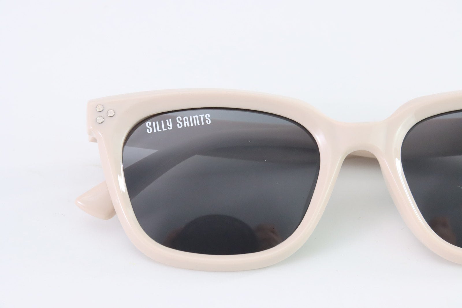 Actual sample of a screen-printed logo on a sunglass lens